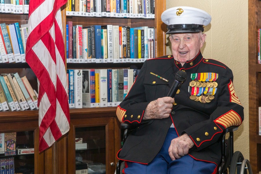 man in marine corps uniform at 100 with medals and microphone